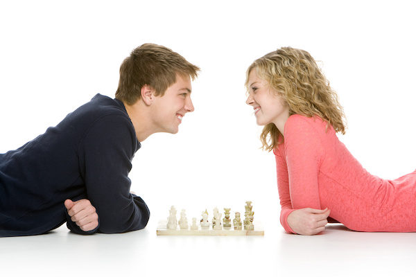 man and woman playing chess