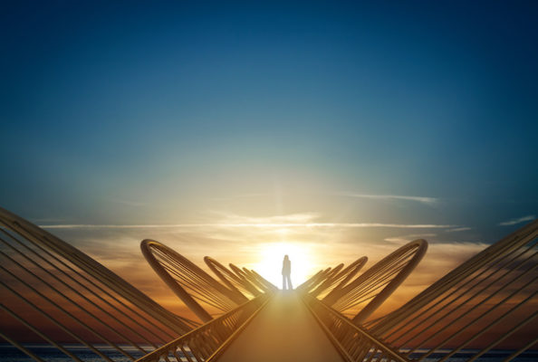 woman on a bridge with sun behind her