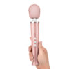 woman holding the rose gold Le Wand Petite