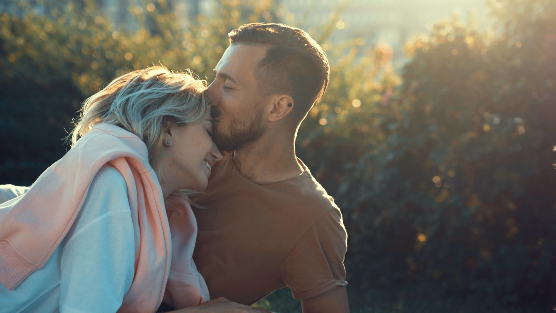 man kissing womans forehead in love