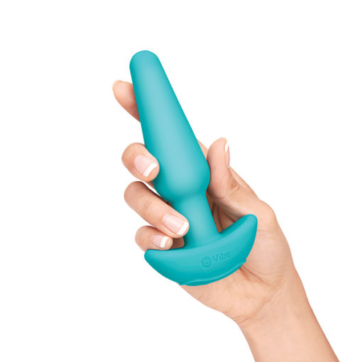 woman holding b-vibe anal training kit medium size plug