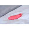 we-vibe melt clitoral stimulator laying on bed sheets