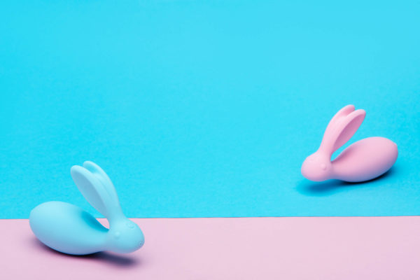 1 pink and 1 blue rabbit sex toy vibrator on colorful background